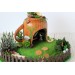 Miniature fairy garden house in tea cup room inside 