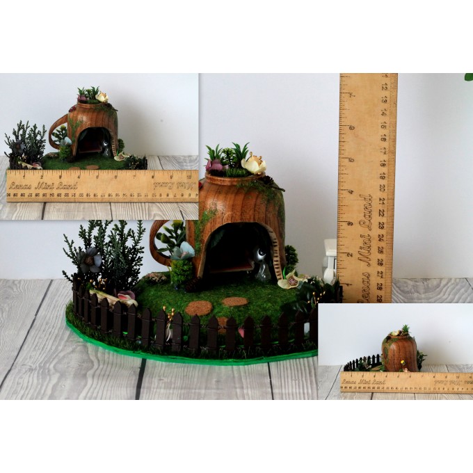 Miniature fairy garden house in tea cup room inside 