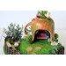 Miniature fairy garden house in tea cup room inside 