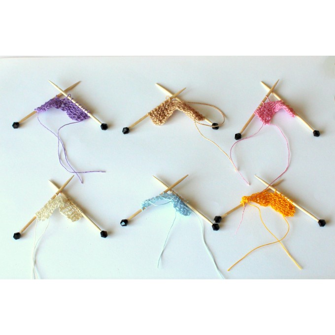 Miniature needles with knitting yarn many colors