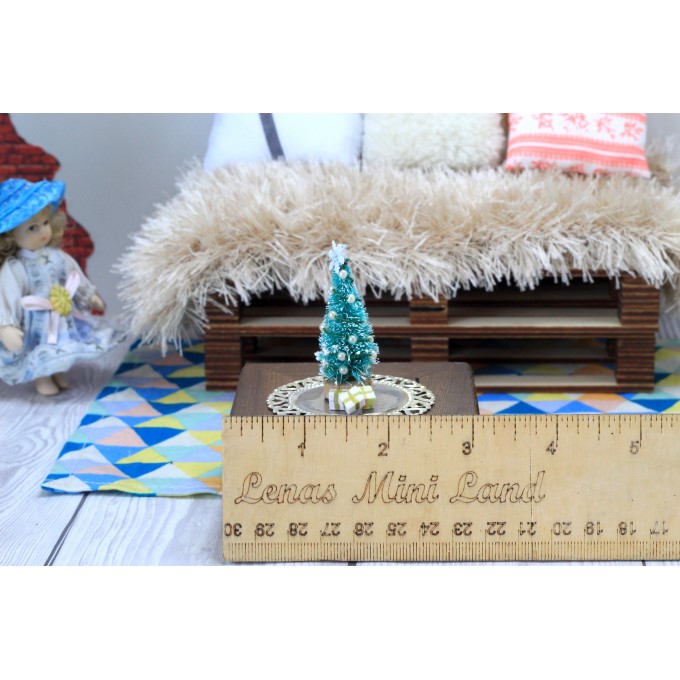 Miniature Christmas tree with presents on the tray. Doll