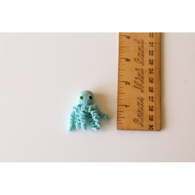 Miniature crochet octopus with hand painted eyes